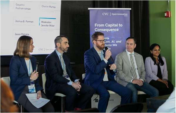 A panel conversation in front of participants